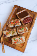 Popular Chinese New Year food. Turnip Cake aka Lo Bak Go. Actually made from radish and rice flour. For own consumption, you can add ground pork, diced Chinese sausage and mushroom and pan fried.
