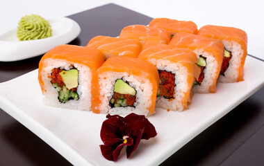 Sushi rolls Japanese delicacies. Japanese traditional rice and fish dishes. Beautiful serving food on a light background with copy space. A set of delicious goodies.