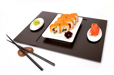 Sushi rolls Japanese delicacies. Japanese traditional rice and fish dishes. Beautiful serving food on a light background with copy space. A set of delicious goodies.