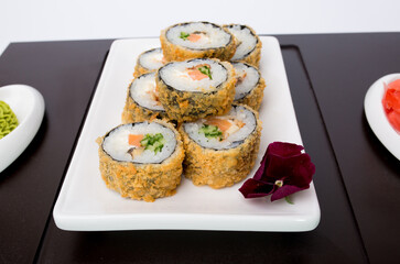 Sushi rolls Japanese delicacies. Japanese traditional rice and fish dishes. Beautiful serving food on a light background with copy space. A set of delicious goodies.