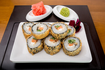 Sushi rolls Japanese delicacies. Japanese traditional rice and fish dishes. Beautiful serving food on a light background with copy space. A set of delicious goodies.