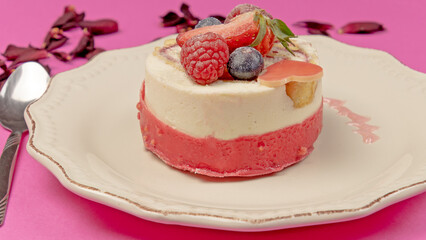 red fruit cake on a pink background