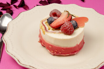 red fruit cake on a pink background