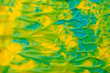 Beautiful abstract background with spots of blue, pink, green, yellow and purple paint. Oil paint, flowing down the canvas, shimmers with galagrophic paints with neon illumination.