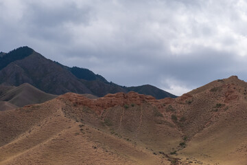 Beautiful red clay mountains eroded on wind. Red mountains or red canyon on the way from Assy plateau to Bartogai reservoir. Mountain canyon landscape.