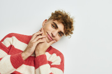 kinky guy in a striped sweater posing light background