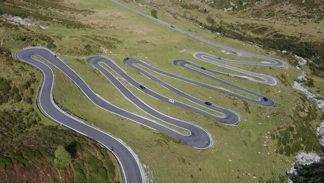 Cars driving along winding mountain road, Susten Pass, Swiss Alps
