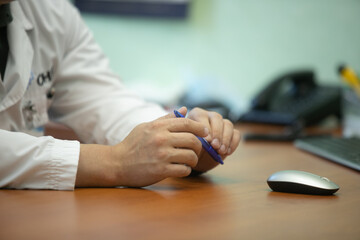 Doctor and patient are discussing something, just hands at the table