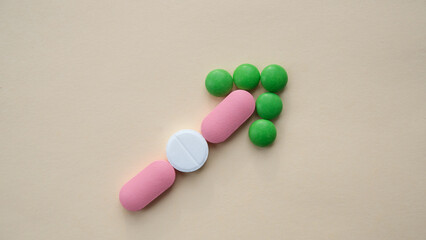 Arrow, pointer from red, green and white pills