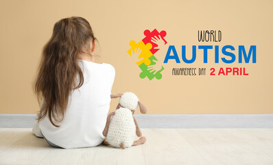 Sad little girl with autistic disorder near color wall, back view. World Autism Awareness day