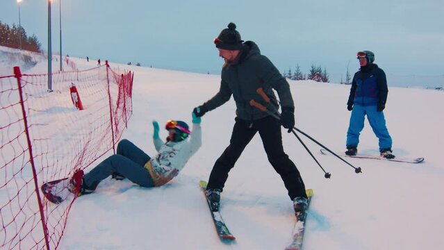 Young woman learns snowboarding and gets stuck in the safety net