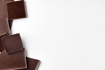 Piece of dark chocolate isolated on white background