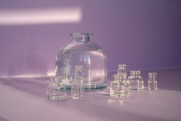 Beautiful abstract background with glass containers on a purple background.