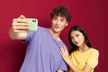 nice guy and girl take a selfie posing hug isolated background