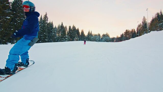 Young man snowboarding in the park