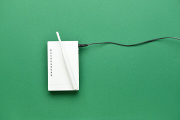 Wi-Fi router with antenna and network cable on color background - obrazy, fototapety, plakaty
