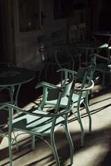 Fototapeta na wymiar blue chairs in a street Greek cafe