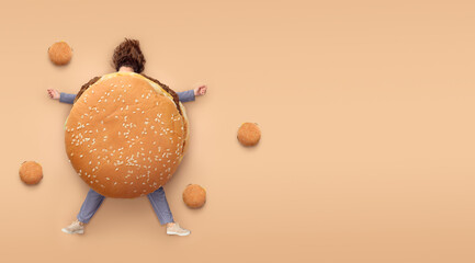 Girl with burger. Fast food concept, overweight. Minimal brown background with copy space. Top view - obrazy, fototapety, plakaty