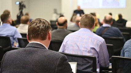 a man leading a discussion in a conference room.