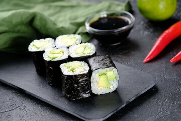 Japanese avocado rolls on a black background