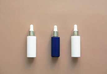 White and blue glass bottles - night and day serum for face care. Cosmetic spa medical skin care, bottle for serum. Aromatherapy oil, natural cosmetics concept.