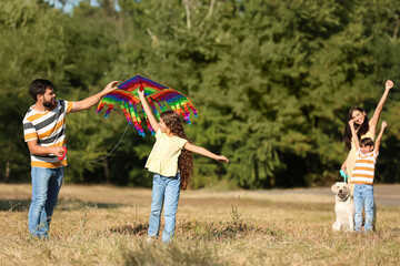 Cute little girl with her father and kite outdoors