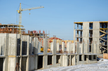 crane tower at construction site. Construction of tall buildings. Construction processes. real construction in the city. The construction of skyscrapers. blue sky on the background.
