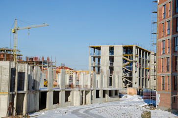 crane tower at construction site. Construction of tall buildings. Construction processes. real construction in the city. The construction of skyscrapers. blue sky on the background.