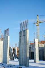 Obraz premium crane tower at construction site. Construction of tall buildings. Construction processes. real construction in the city. The construction of skyscrapers. blue sky on the background.