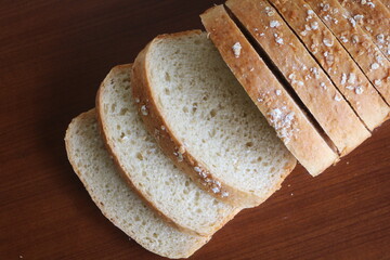 freshly baked sliced bread on rustic wooden table
