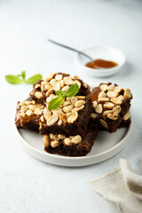 Traditional homemade brownies with caramel and peanut
