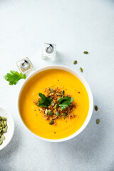 Traditional pumpkin soup with seeds and parsley