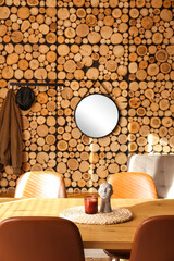 Dining table with candle and decor in stylish room