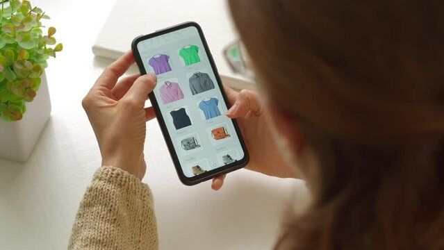 Online shopping using smartphone. A woman buys goods online holding a mobile phone.