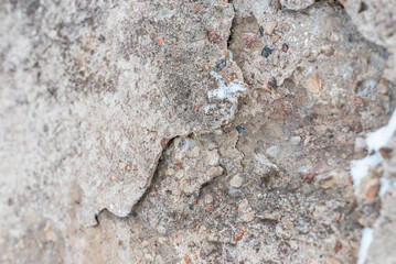 Cracked concrete wall gray cement surface background.cracked grey stone wall in winter.close-up.