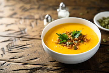Traditional pumpkin soup with seeds and parsley