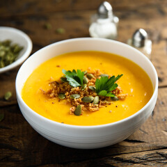 Traditional pumpkin soup with seeds and parsley