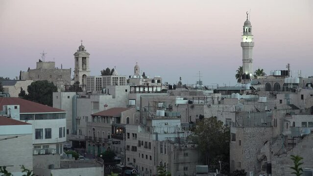Call for prayer and view towards Mosque of Omar and Church of Nativity in Bethlehem, religion and urban landscape in the West Bank
