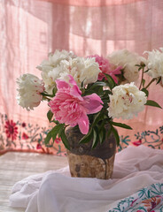 Still life with white and pink peonies in a old ceramic vase - 487966562