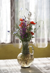 Still life with fresh wild flowers in vase - 487966775