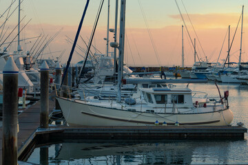 Marina at Port Stephens, Nelson bay harbour, Australia. Sunrise at luxury yachts and sailing boats moored around marina.