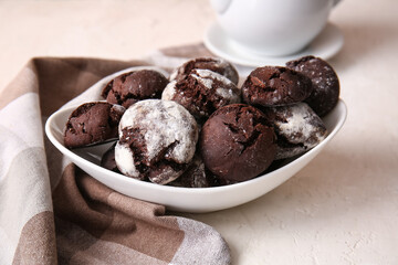 Bowl of chocolate brownie cookies on light background