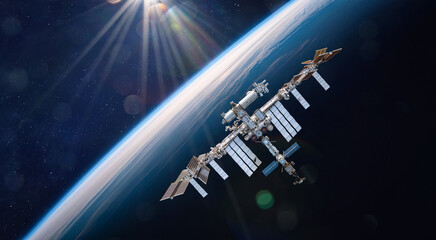 Fototapeta na wymiar International Space station on orbit of Earth. Space collage with iss and planet surface. Astronauts in space. Elements of this image furnished by NASA