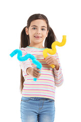 Cute little girl with Pop Tubes on white background