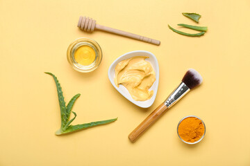 Bowl with turmeric mask, powder and honey on beige background