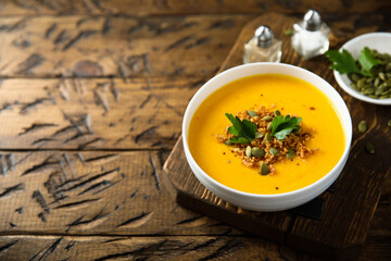 Traditional pumpkin soup with seeds and parsley