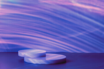 Abstract minimal scene - empty stage, circle podiums on dark blue background with neon disco light caustic effect. Pedestal for cosmetic, product, packaging mockups presentation