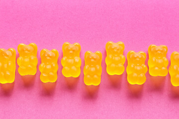 Sweet jelly bears on pink background, closeup