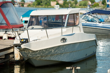Fototapeta na wymiar white motorboat moored at the river pier