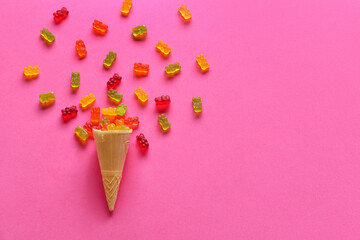 Sweet jelly bears and waffle cone on pink background